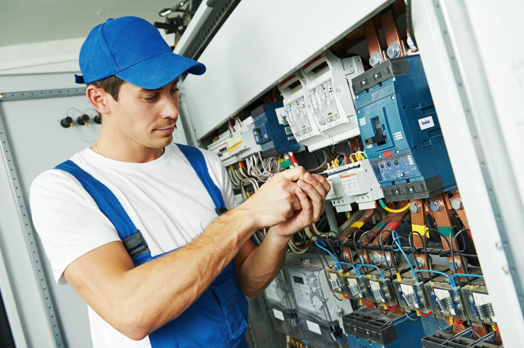 Technician working in a building automation control panel